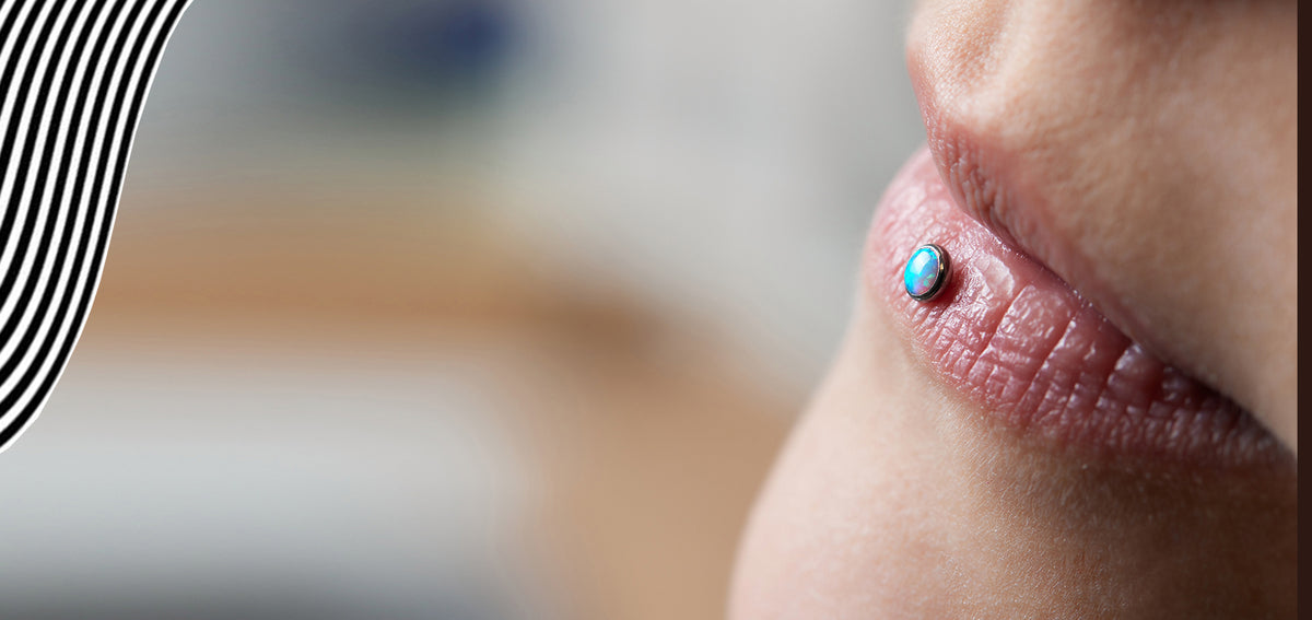 Close-up of lips in profile with a light blue gem stud on the lower lip