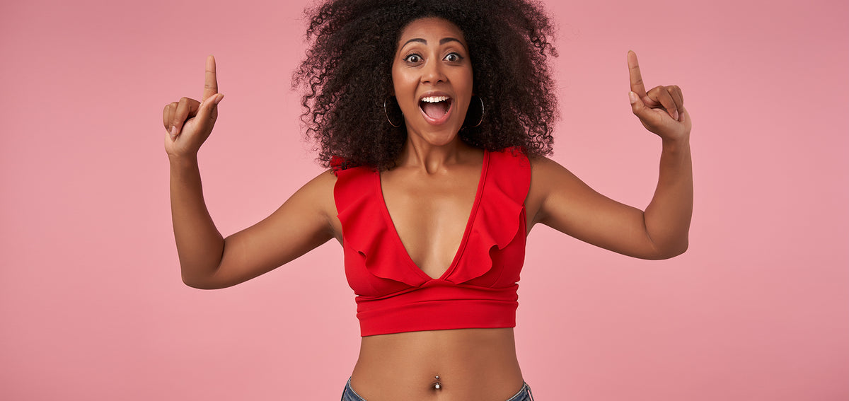Informational image of a smiling woman with belly piercing