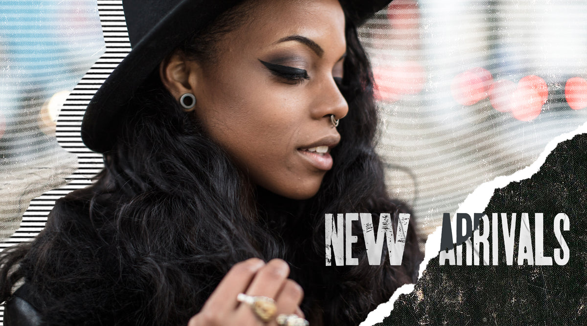 New Arrivals: woman in a black hat wearing a black plug in her stretched lobe and a small nose hoop